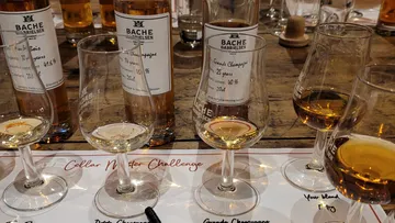 Whiskey glasses and bottles on a table.