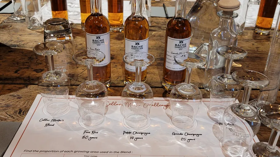 Bottles and glasses on a wooden table.