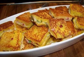 Grilled sandwiches stacked in a white dish.
