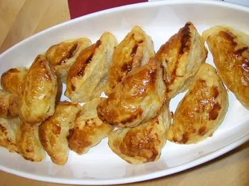 Golden pastries in a white dish.