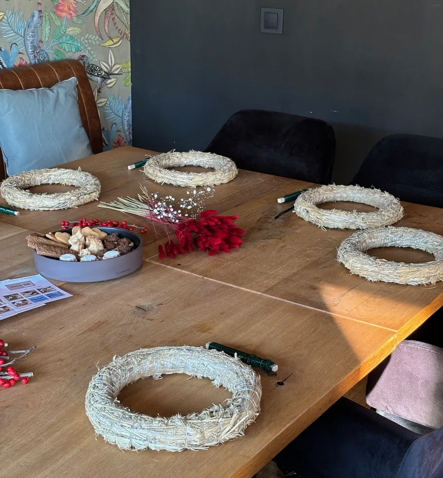 Wreath materials on a wooden table.
