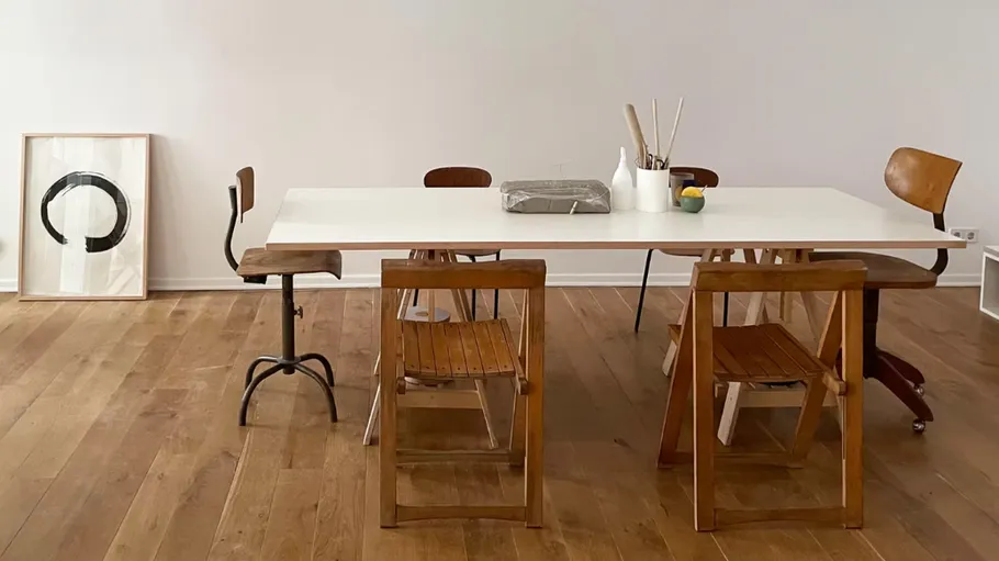 Minimalist dining room with wooden chairs.