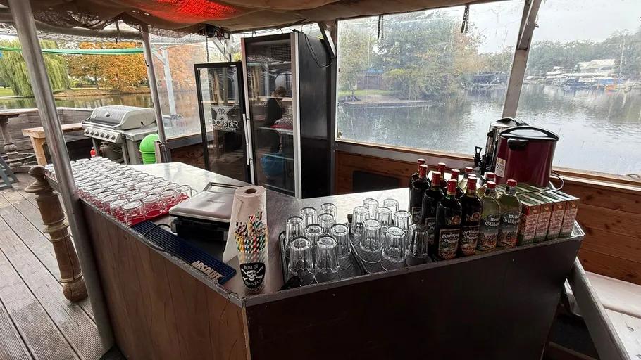 Outdoor bar on a boat near a lake.