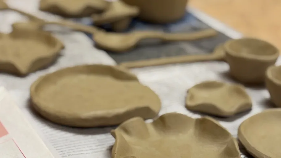 Clay plates and bowls on newspaper drying.
