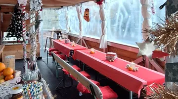Festively decorated room with tables and chairs.