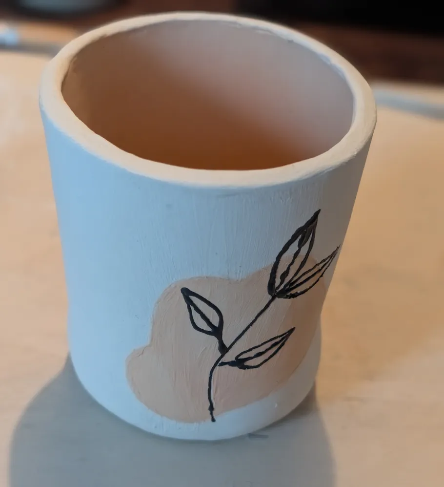 Decorative ceramic cup with floral artwork.