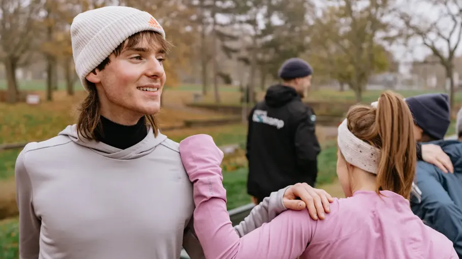 People exercising in a park during autumn.