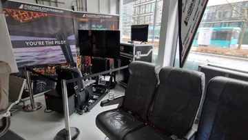 Flight simulator setup in a modern room.