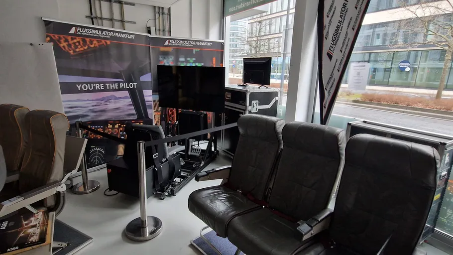 Flight simulator setup with seats in office.