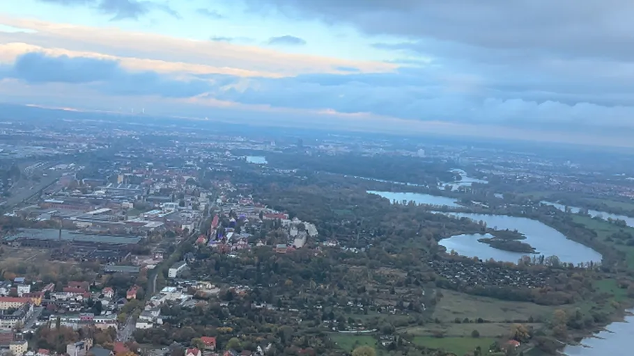 Luftaufnahme der Stadt mit Fluss und Wolken.