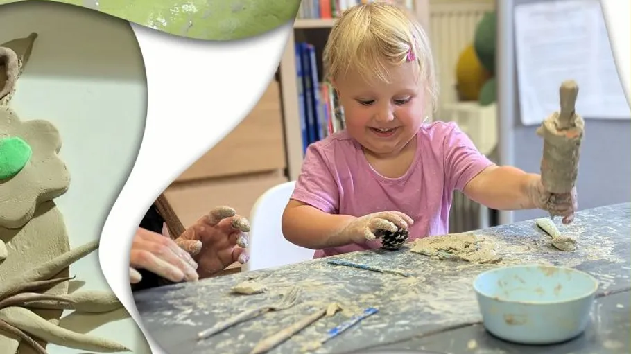 Child playing with clay at a table.