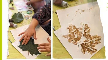 Hands pressing leaf onto paper for leaf print.