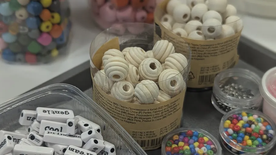 Assorted beads on a table for crafting.