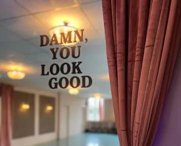 Mirror with text in elegant room.