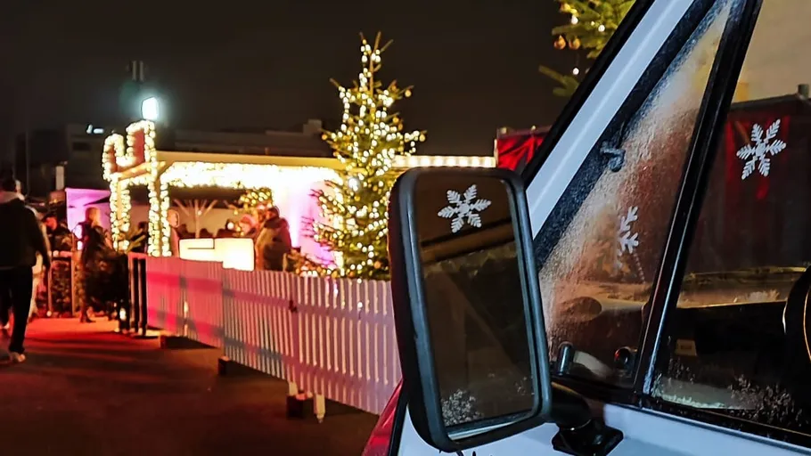 Decorated Christmas market scene with lights.