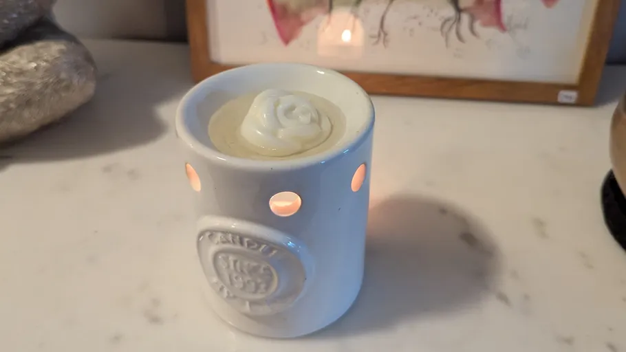 Candle holder with a lit candle inside.