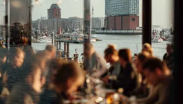 People in a restaurant with waterfront view.