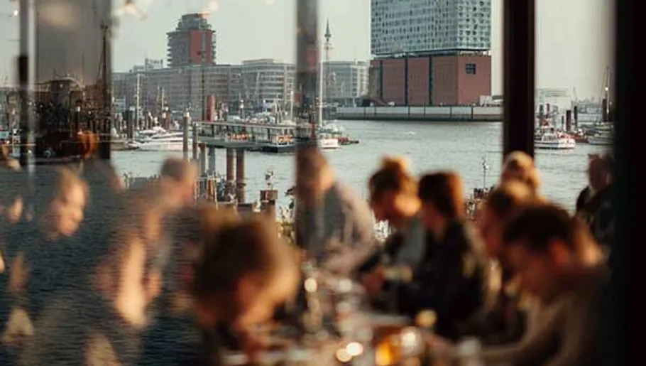 People in a restaurant with waterfront view.