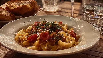 Pasta dish with tomato sauce on table.