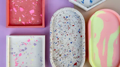 Colorful terrazzo trays on purple background.