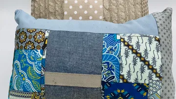 Patchwork pillows with various patterns and colors.