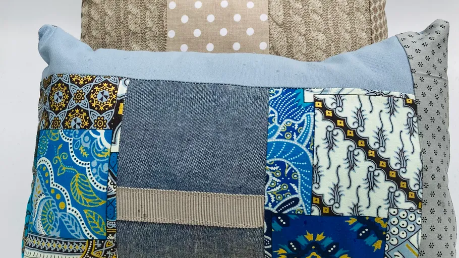Patchwork pillows with various patterns and colors.