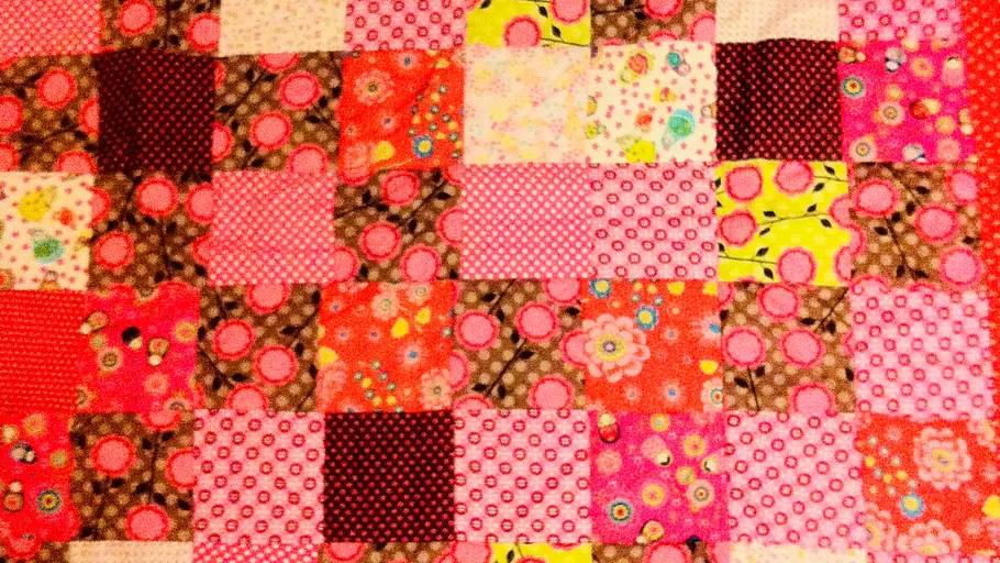 Colorful quilt with various patterned squares.