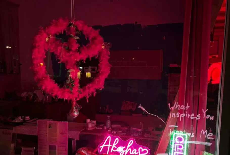 Pink heart-shaped wreath in a pink-lit room.