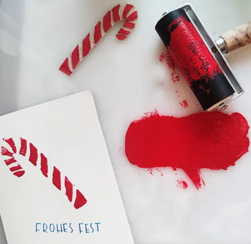 Candy cane, paint roller, holiday card, red paint.