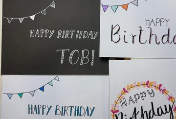 Handmade birthday cards on a table.