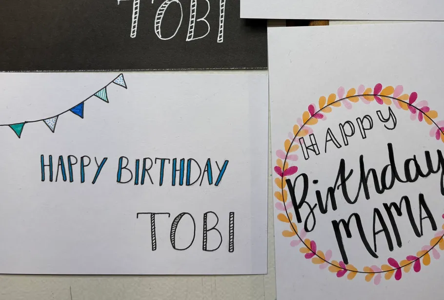 Three birthday cards pinned on wall.