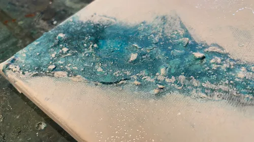 Textured blue and white abstract painting.