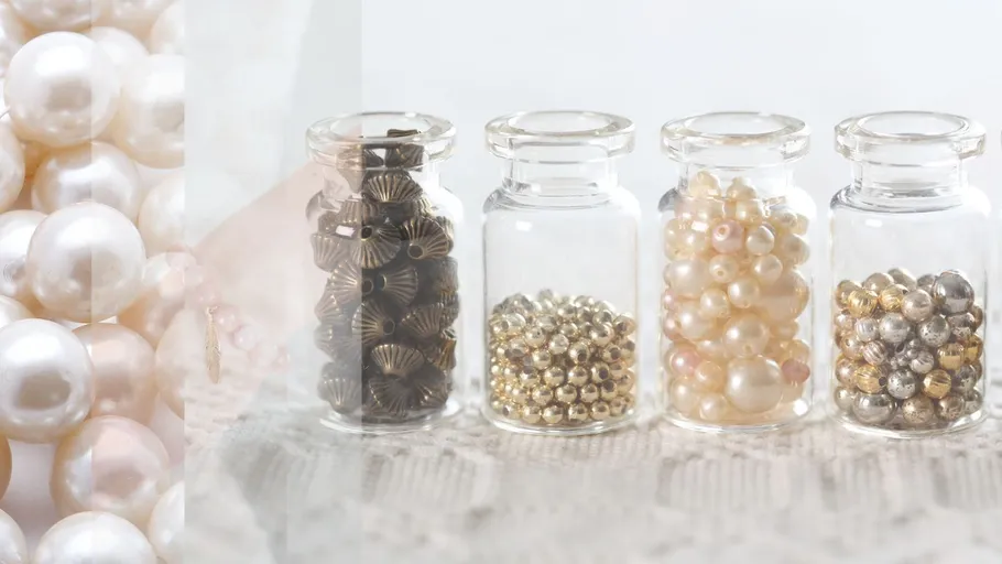 Four jars filled with various beads.