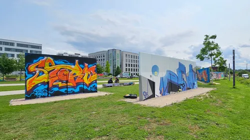 Colorful graffiti on outdoor walls near buildings.