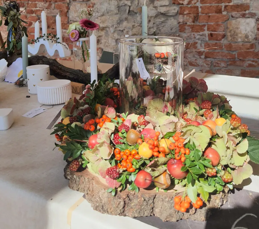 Decorative arrangement with berries on a table.