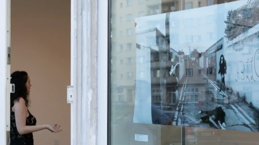 Woman gestures inside an art gallery.