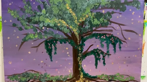Tree with colorful leaves against purple sky.