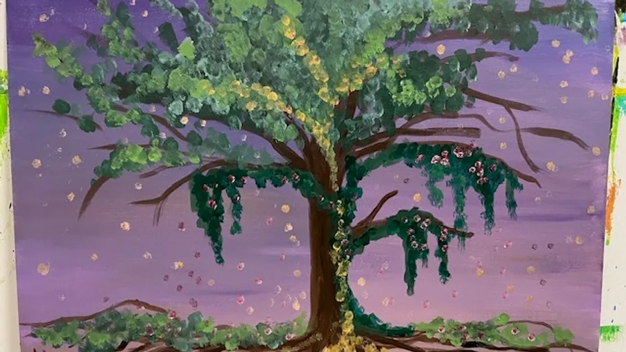 Baum mit bunten Blättern vor violettem Himmel.