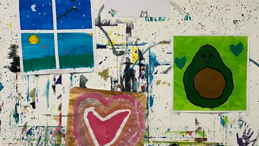 Colorful paintings on a splattered wall.