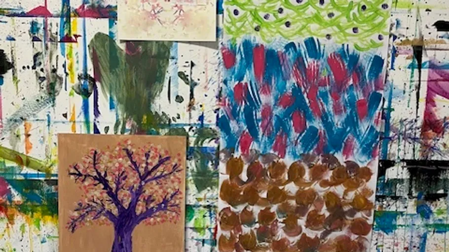 Colorful abstract paintings displayed on wall.