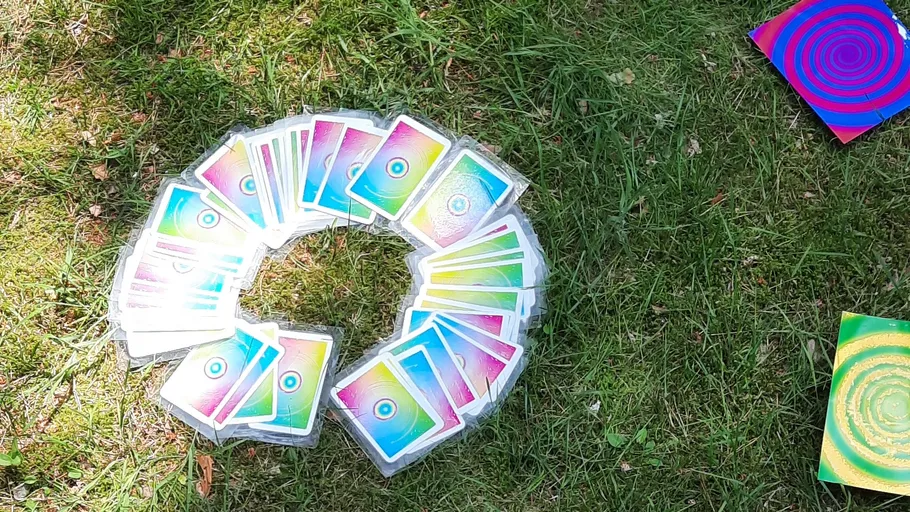 Colorful cards arranged in a circle on grass.
