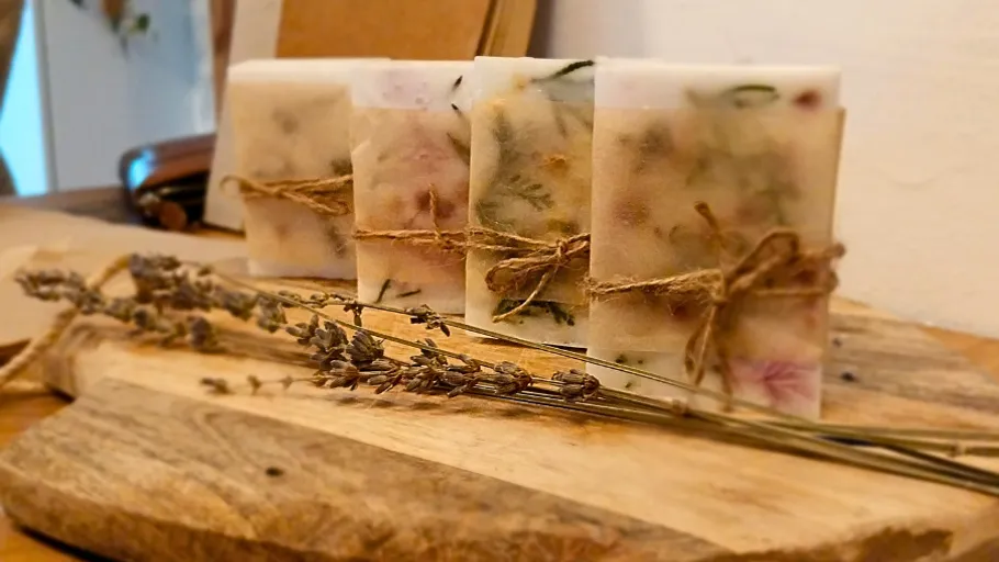 Decorative soap bars tied with twine, on wood.