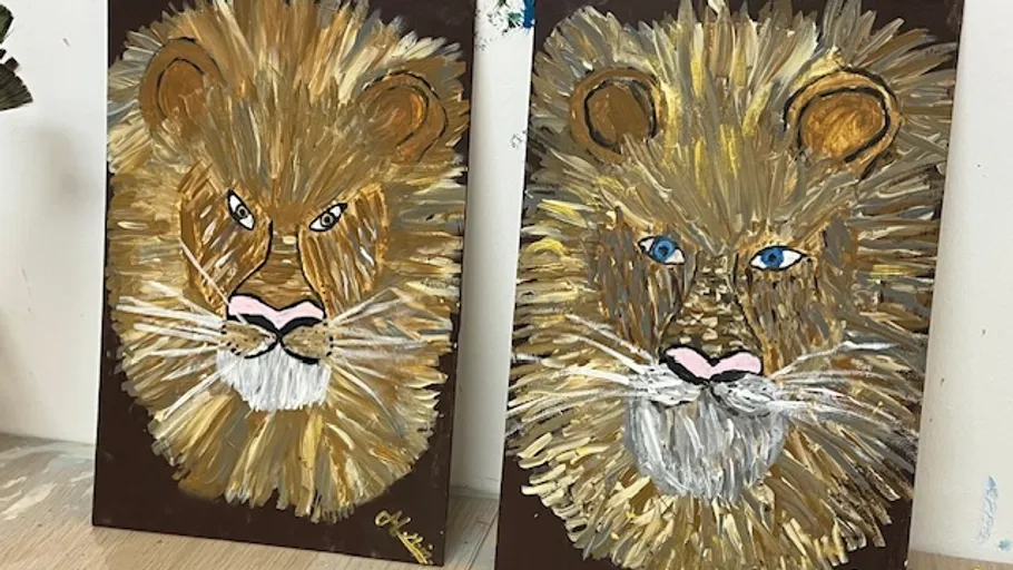 Two lion paintings on brown canvases.