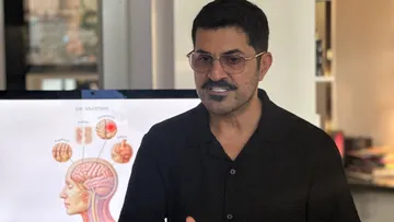 Man explaining brain anatomy in office.