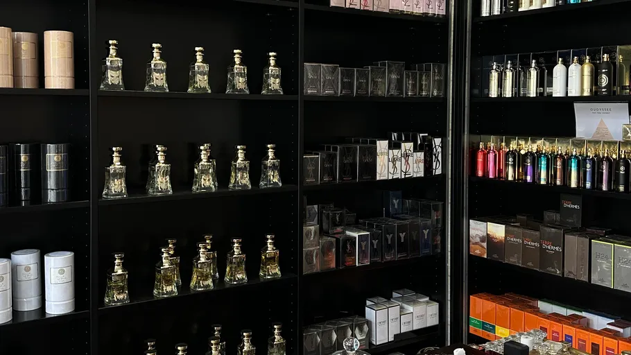 Shelves displaying various perfume bottles and boxes.
