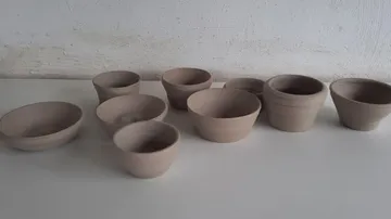 Clay pots on a white surface.