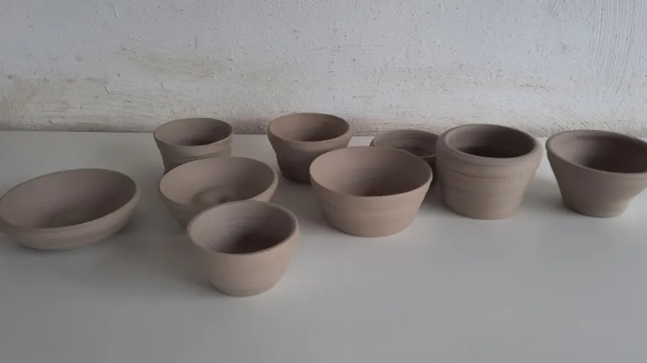 Clay pots on a white surface.
