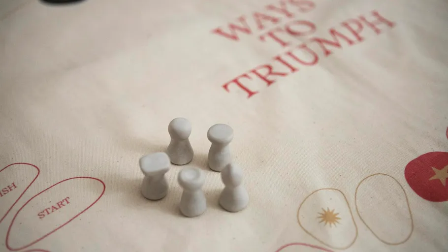 Game pieces on fabric game board surface.