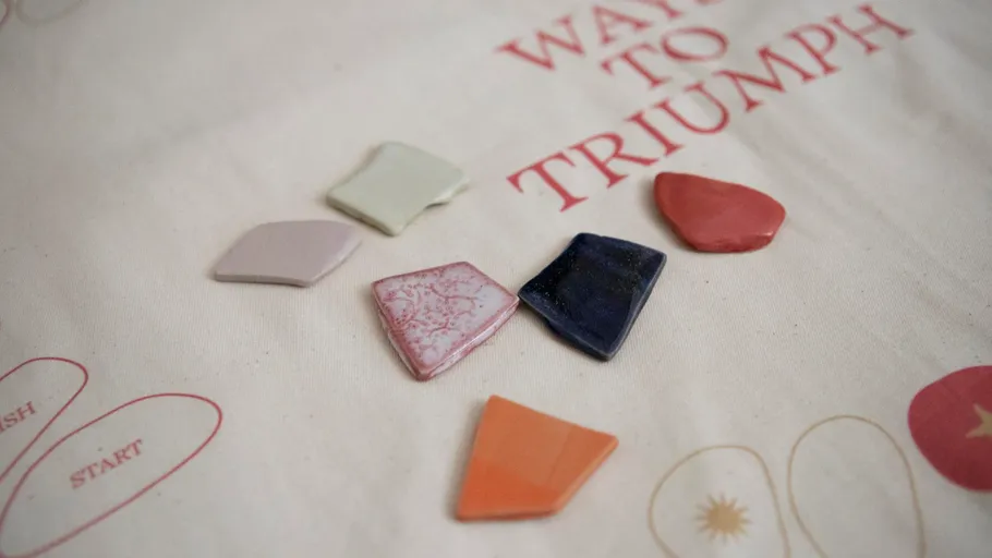 Colorful ceramic pieces on decorative fabric.