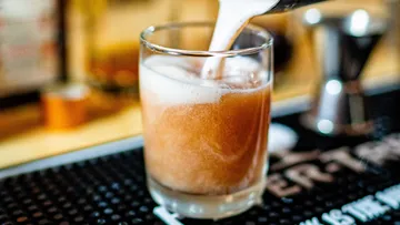 Foamy drink being poured into a glass.